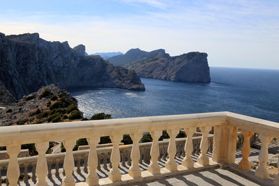 Scenic view of sea and mountains against sky