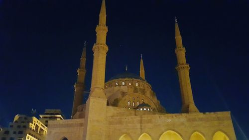 Low angle view of illuminated cathedral against sky