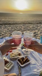 Scenic view of picnic at the beach with the sand and sunset