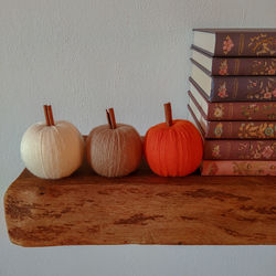 Close-up of pumpkins on table against wall