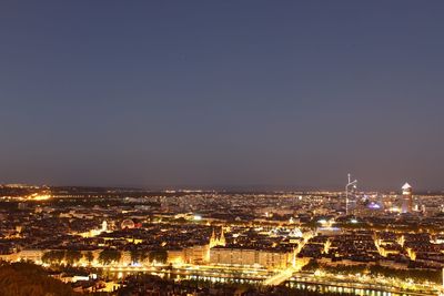 Aerial view of city lit up at night