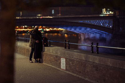 Couple embracing by the thames