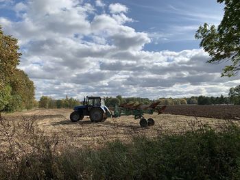 Tractor on field against sky