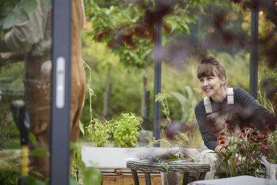 Woman sitting in greenhouse