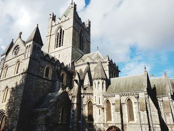 Low angle view of cathedral against cloudy sky