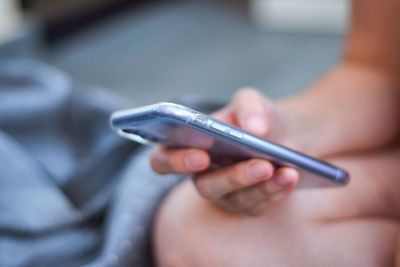 Close-up of woman holding mobile phone