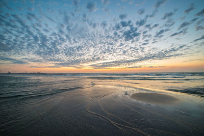 Scenic view of beach against sky during sunset