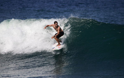 Side view of man surfing in sea