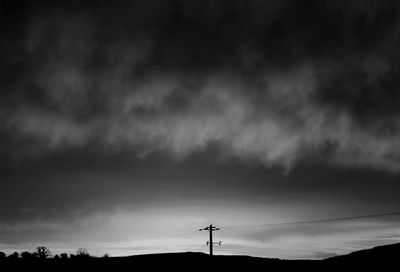 Low angle view of silhouette trees against sky