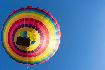 Low angle view of hot air balloon against clear blue sky