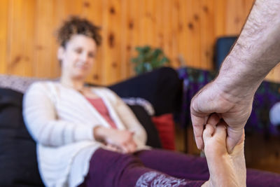 Low section of couple holding hands