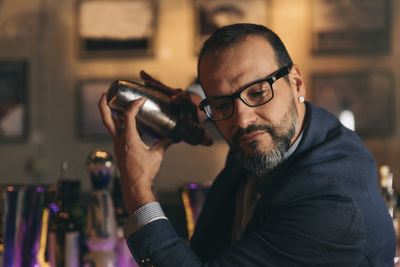 Male bartender preparing cocktail at bar counter