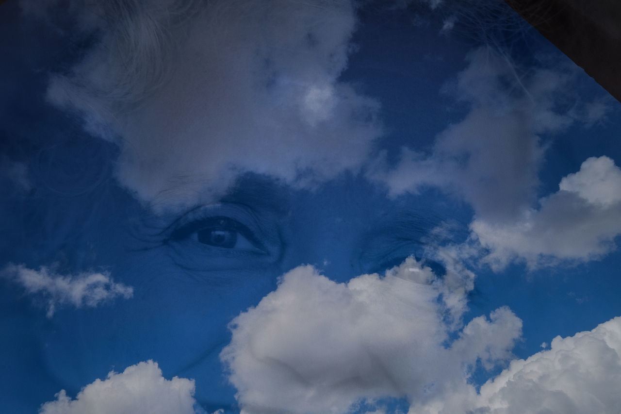 CLOSE-UP OF BLUE SKY AND CLOUDS IN SNOW