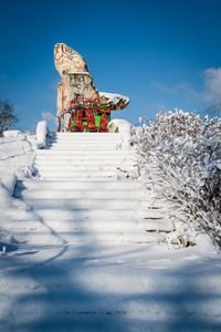 Low angle view of sculpture on snow covered landscape