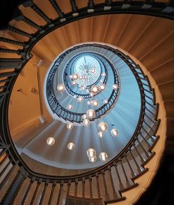 Directly below shot of decorations amidst spiral staircases in building