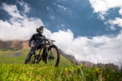 Male athlete cyclist in helmet and protective mask outdoors. mtb rider in mountainous terrain