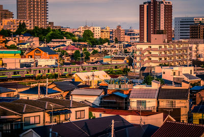 High angle view of buildings in city at sunset