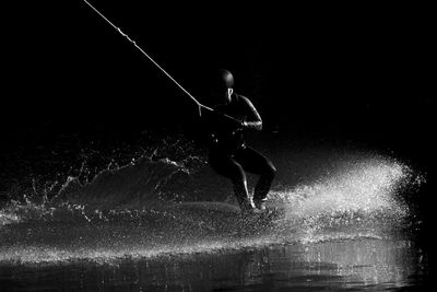 Man splashing water at night