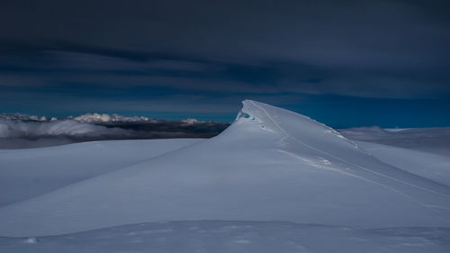 Snow covered mountain against sky