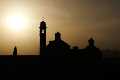 Low angle view of bell tower against sky during sunset