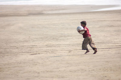 Full length of woman walking on beach