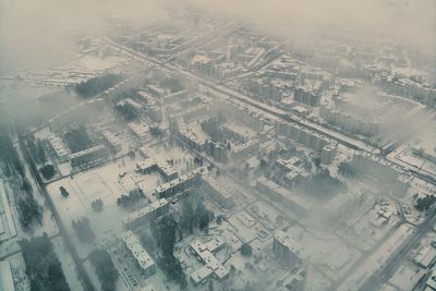 Aerial view of street amidst buildings in city during winter