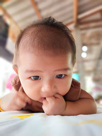 Close-up of cute baby girl at home