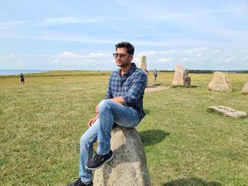 Portrait of young man on land against sky