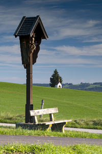 Lifeguard hut on field against sky