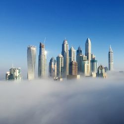 Skyscrapers in city against clear sky