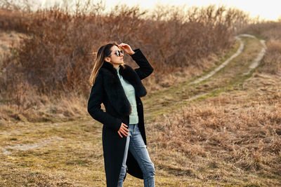 Woman photographing on field