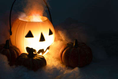 Close-up of illuminated pumpkin against dark background