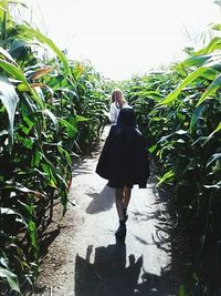 Woman standing by plants