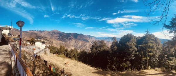 Panoramic view of landscape against blue sky