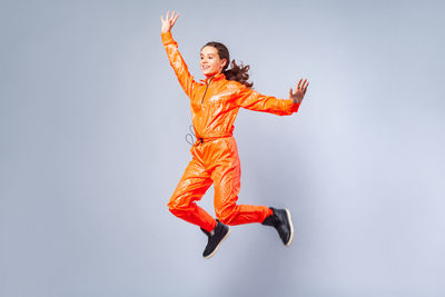 Girl jumping against white background