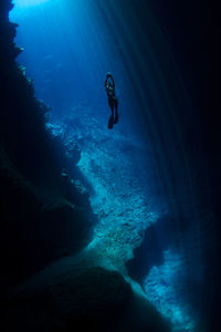 Silhouette woman swimming in sea