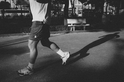 Low section of man with umbrella on the ground