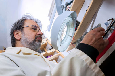 Electronic engineer is working in his laboratory