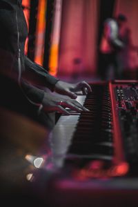 Midsection of man playing piano