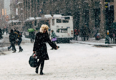 Woman standing on snow covered landscape