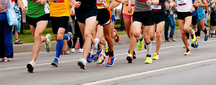 Low section of people walking on road