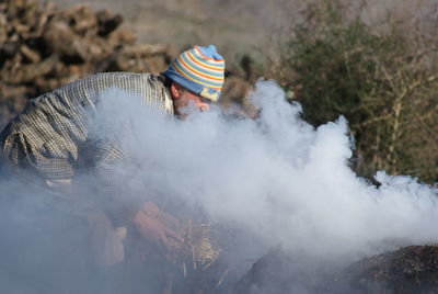 Man standing by smoke