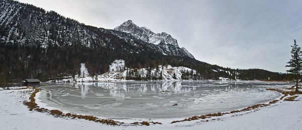 Scenic view of frozen lake against sky during winter