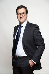 Portrait of man standing against white background