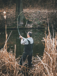 Man fishing in lake