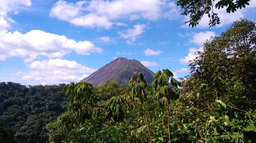 Scenic view of mountains against cloudy sky