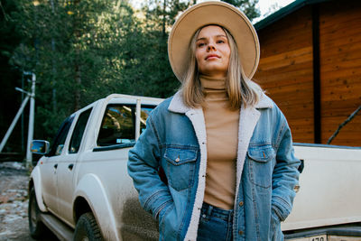 Young woman looking away while sitting in car