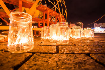 Close-up of illuminated light bulb on table