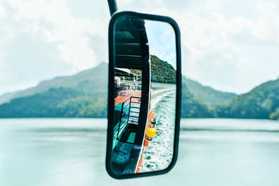 Graffiti on lake against sky