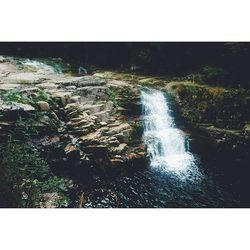 Scenic view of water flowing through rocks